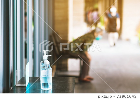 Blue alcohol gel bottle for hands cleaning to prevent the spreading of the Corona virus (Covid-19), Place the entrance service for customers  in the cafe. Healthcare concept. New normal lifestyle. 73961645