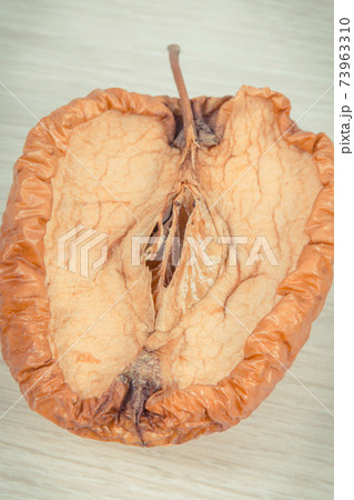 Spoiled apple with mold, unhealthy and disgusting fruit 73963310