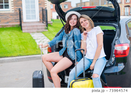 Two young Caucasian women are traveling in a rented car Two young Caucasian women are traveling in a rented car 73964574