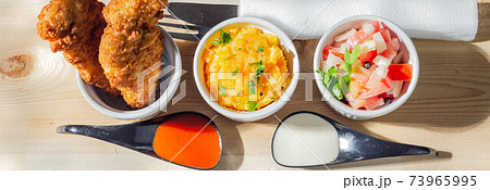 Breaded and herbed chicken breast fillet served with mash potatoes and tomato with onions Breaded and herbed chicken breast fillet served with mash potatoes and tomato with onions 73965995