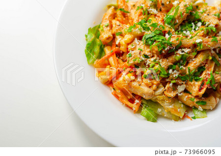 Piri piri style chicken on a bed of wholewheat pasta and vegetables, with a cool sour cream and chive dressing Piri piri style chicken on a bed of wholewheat pasta and vegetables, with a cool sour cream and chive dressing 73966095