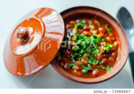 A hearty serving of baked beans in a ceramic dish, a healthy and nutritious meal 73966607