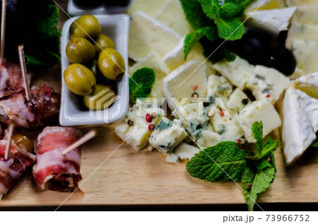 set of different cheeses on a wooden board, cheese board, delicious snack, healthy and exclusive food 73966752