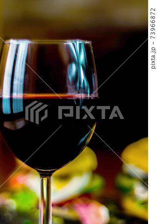 Red wine in a wine glass, celebration of a moment with a glass of wine, exquisite liquor for gourmets 73966872