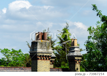 Typical English chimneys on the roofs of London buildings Typical English chimneys on the roofs of London buildings 73967254
