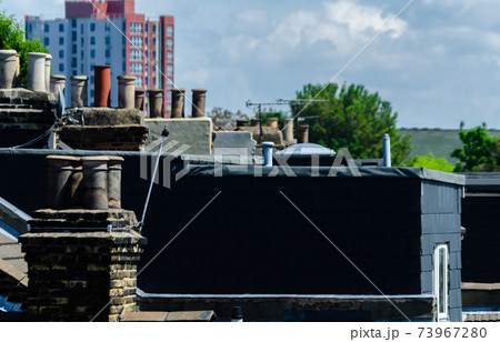 Typical English chimneys on the roofs of London buildings 73967280