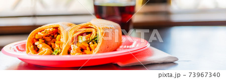 Chicken breast with piri piri sauce and lettuce in a chili tortilla wrap 73967340
