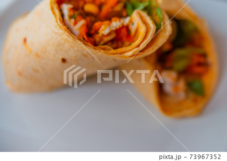 Chicken breast with piri piri sauce and lettuce in a chili tortilla wrap 73967352