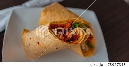 Chicken breast with piri piri sauce and lettuce in a chili tortilla wrap Chicken breast with piri piri sauce and lettuce in a chili tortilla wrap 73967353