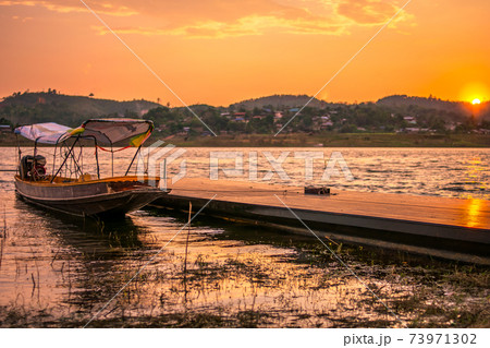 Reflection of Single Boat with Burning Sky During Sunrise/Sunset Reflection of Single Boat with Burning Sky During Sunrise/Sunset 73971302