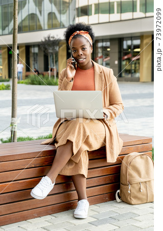 African businesswoman working outdoors African businesswoman working outdoors 73972099
