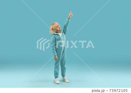 Childhood and dream about big and famous future. Pretty curly boy isolated on blue background Childhood and dream about big and famous future. Pretty curly boy isolated on blue background 73972105