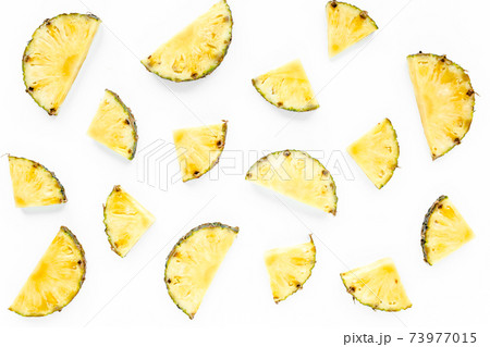 Slices pineapple with green leaves isolated on white background. Flat lay, top view 73977015
