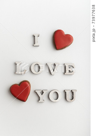 Romantic inscription I LOVE YOU and red heart shaped gingerbread cookies, white background. Valentines day Romantic inscription I LOVE YOU and red heart shaped gingerbread cookies, white background. Valentines day 73977638