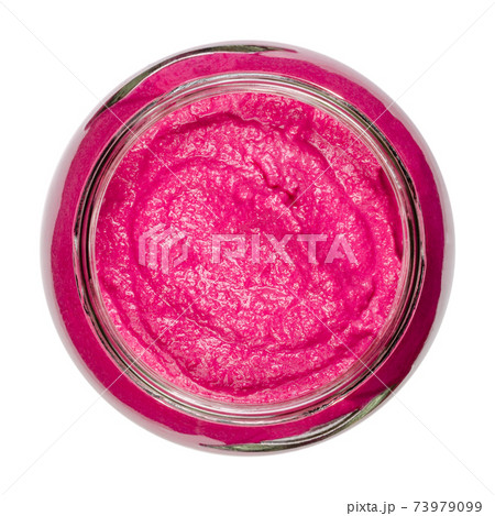 Beet spread, in a glass jar, from above. Beetroot bread spread, with an intense purple color, made with cooked red beets. Colorful, healthy and vegan food. Close-up, on white background, food photo. 73979099