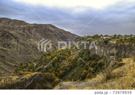 The village of Garni on a basalt plateau, covered with autumn gardens, descends to the mountain river Azat The village of Garni on a basalt plateau, covered with autumn gardens, descends to the mountain river Azat 73979939
