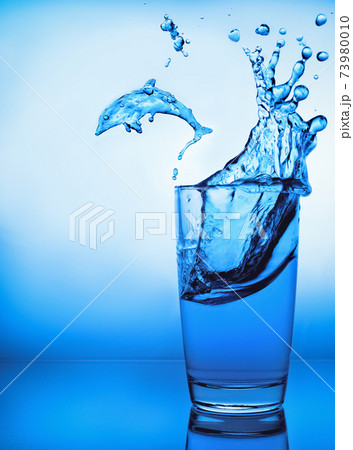 glass of water. splash of water. dolphin figure out of water glass of water. splash of water. dolphin figure out of water 73980010