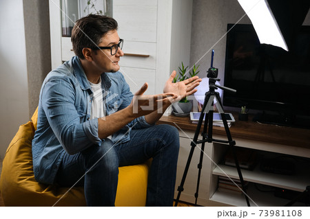 Young male blogger recording video at home Young male blogger recording video at home 73981108