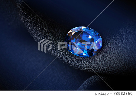 natural blue sapphire on black background 73982366