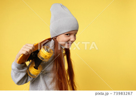 little child girl with yellow skateboard 73983267
