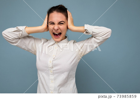 Portrait of emotional young beautiful brunette woman with sincere emotions wearing white shirt 73985859