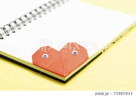 Bookmark heart with eyes for a book on a yellow background close up 73985933