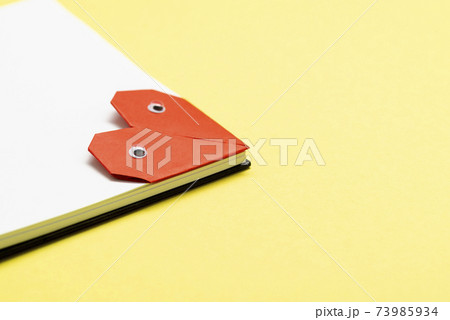Bookmark heart with eyes for a book on a yellow background close up 73985934