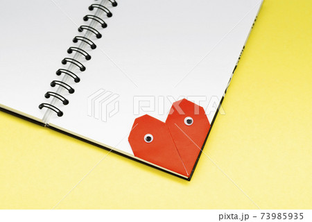 Bookmark heart with eyes for a book on a yellow background close up 73985935