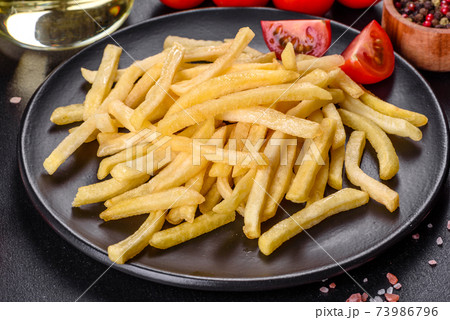 Fresh hot french fries with salt vegetables and spices 73986796