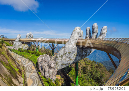 Famous tourist attraction - Golden bridge at the top of the Ba Na Hills, Vietnam 73993201