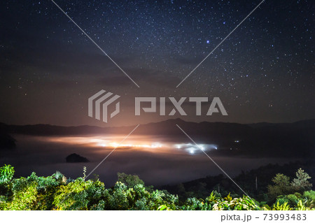 foggy above mountain againts sky 73993483