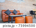 Leather orange sofa with brick wall brown background 73994500