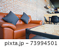 Leather orange sofa with brick wall brown background 73994501