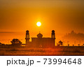 silhouette of a mosque againts colorful sunrise 73994648