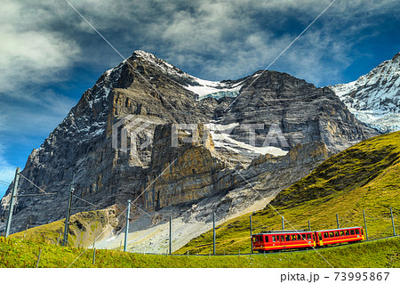 Electric tourist train and Eiger North face,Bernese Oberland,Switzerland 73995867