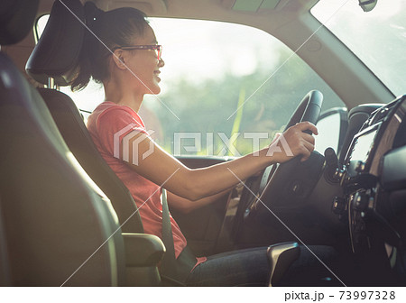 Asian woman driver driving off road car in the nature Asian woman driver driving off road car in the nature 73997328