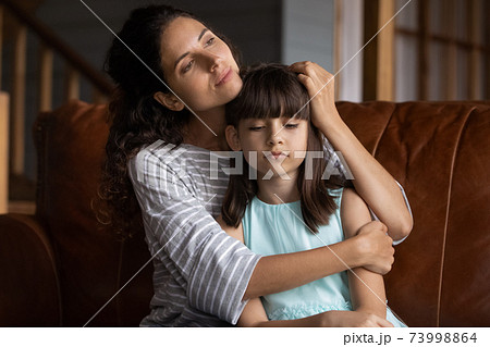 Close up caring mother hugging, calming upset little daughter Close up caring mother hugging, calming upset little daughter 73998864
