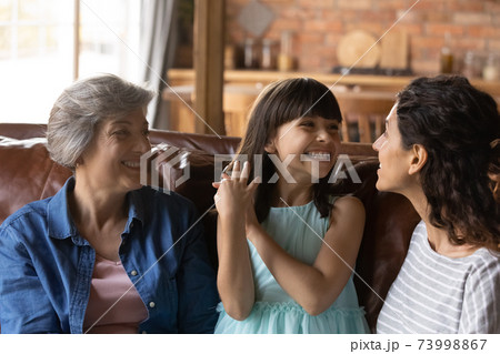 Close up little girl with mother and grandmother having fun Close up little girl with mother and grandmother having fun 73998867