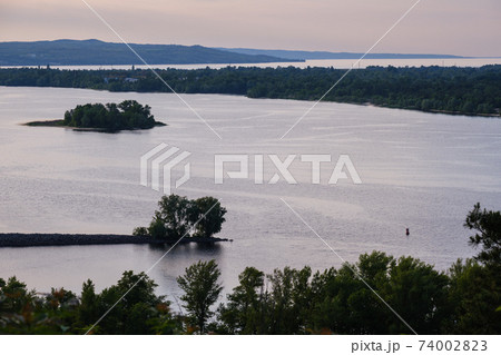 Dnipro river summer evening view from Taras Hill or Chernecha Hora (Monk Hill - important landmark of the Taras Shevchenko National Preserve, Kaniv, Cherkasy Region, Ukraine. Dnipro river summer evening view from Taras Hill or Chernecha Hora (Monk Hill - important landmark of the Taras Shevchenko National Preserve, Kaniv, Cherkasy Region, Ukraine. 74002823