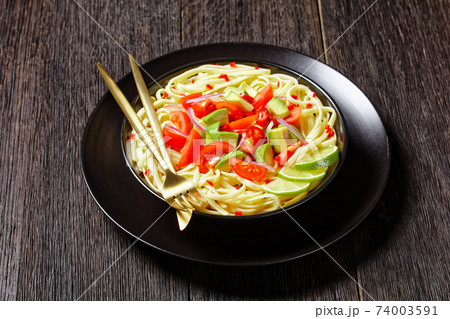 pasta with avocado, tomatoes and lime, top view pasta with avocado, tomatoes and lime, top view 74003591