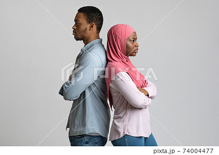 Frustrated african american muslim couple posing on grey Frustrated african american muslim couple posing on grey 74004477