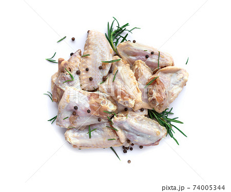 Raw chicken wings with garlic, pepperand rosemary isolated 74005344