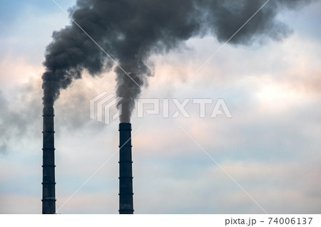 Coal power plant high pipes with black smoke moving up polluting atmosphere. Coal power plant high pipes with black smoke moving up polluting atmosphere. 74006137