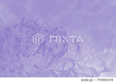 Light violet background of shredded paper. Strips of sliced corrugated paper for packing 74006349