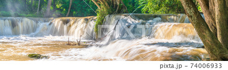 Water falls in tropical rainforest with rock and tree Water falls in tropical rainforest with rock and tree 74006933