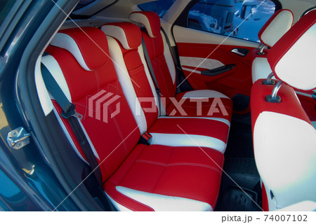 Car seats. Car interior details. White red leather with stitching Car seats. Car interior details. White red leather with stitching 74007102