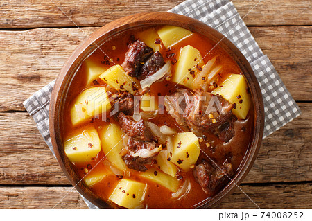 African style Lamb and potato stew with onions close-up in a bowl. horizontal top view 74008252