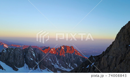 Epic red dawn on top of snowy mountains. 74008843