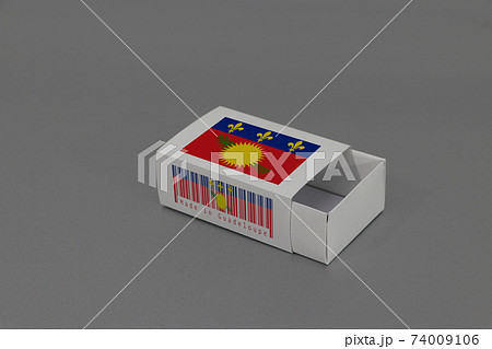 Guadeloupe Local lag on white box with barcode and the color of nation flag on grey background 74009106