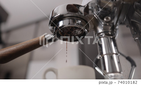 low angle shot of espresso pour with naked portafilter low angle shot of espresso pour with naked portafilter 74010182